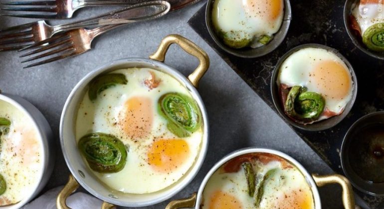 Spicy Baked Eggs with Fiddleheads & Prosciutto